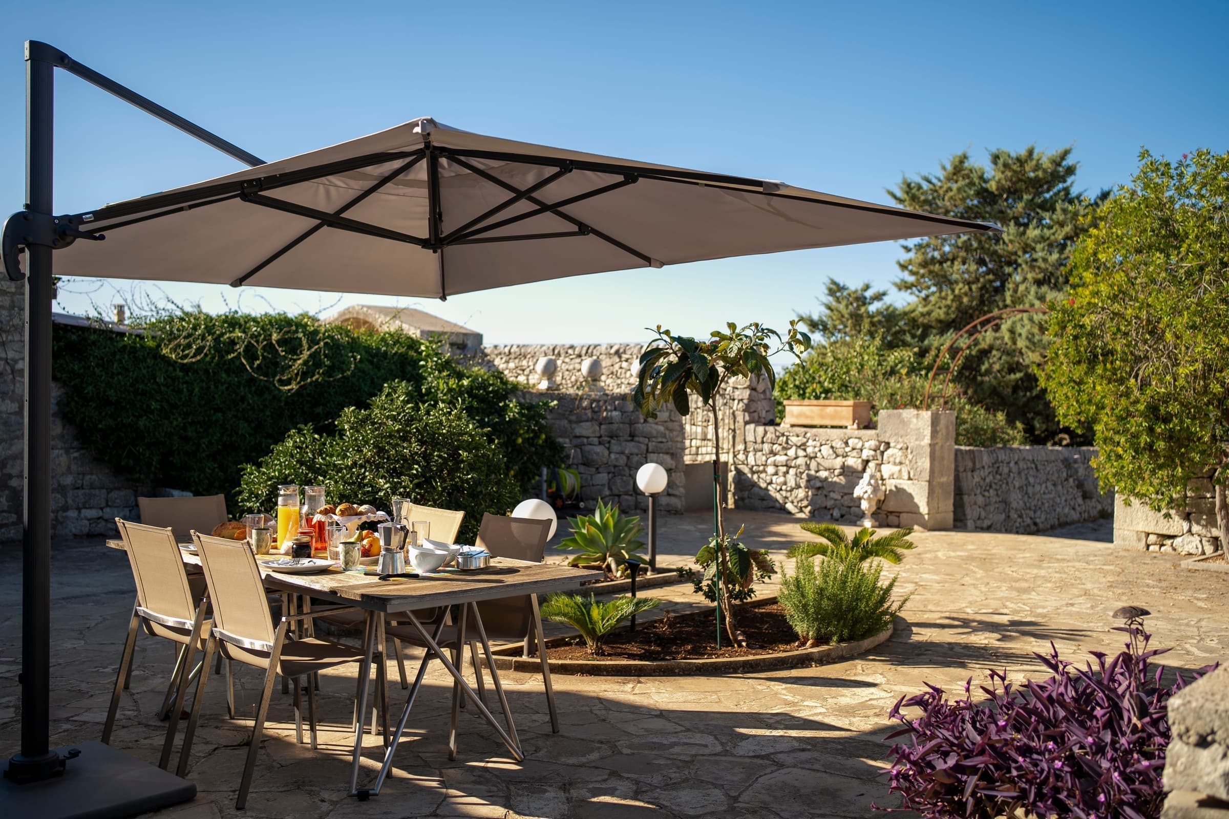 Garden loungers beneath shaded trees